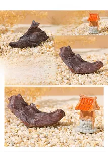 Detailed view of resin driftwood and stone well ornaments for aquarium landscaping