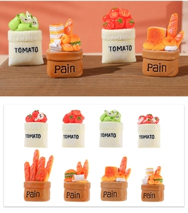 Macro detail of miniature resin tomato and bread baskets for creative desktop decoration