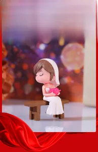 Detail of miniature bride figurine in white dress with flowers on brown wood bench