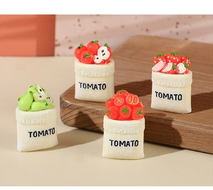 Macro detail of miniature resin fruit figurines in tomato themed pouch bases