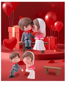 Detailed view of cartoon wedding couple figurines with a wooden texture bench for DIY decor