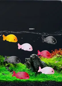 Macro view of colorful resin goldfish figurines used for aquarium landscape decoration