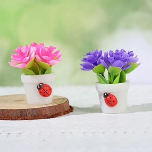 Miniature dollhouse potted plants with pink and purple flowers and cute ladybug detail