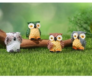 Set of four resin owl figurines in moss landscape with shy poses for garden decor