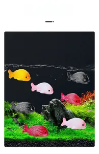 Detailed view of colorful resin goldfish figurines in a simulated aquarium landscape