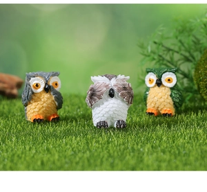 Three cute resin owls in shy poses on artificial green moss for micro landscape decor