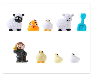 Macro detail of resin farm animal figurines including a sheep and miniature farmer models