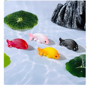 Detailed macro view of four colorful resin koi fish figurines for aquarium decoration