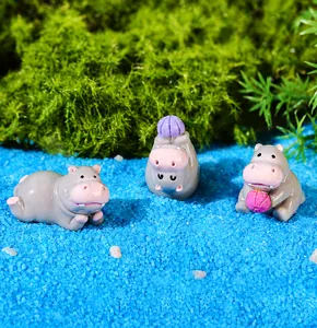 Detailed view of three cute grey resin hippo figurines in a mossy micro landscape set