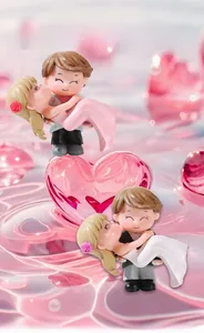 Romantic miniature couple figures with groom carrying bride over pink water