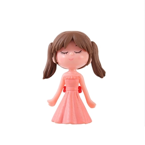 Cute resin girl figurine with pink dress and brown pigtails for desktop decor