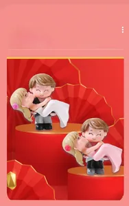 Close-up of cute miniature resin figurines showing a groom carrying a bride
