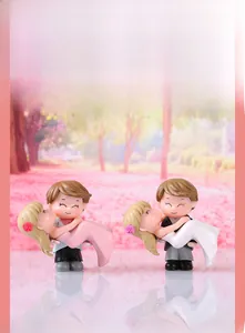 Detailed view of wedding couple figurines with groom carrying bride in romantic poses