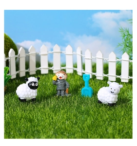 Miniature farm animals set with sheep and farmer figures on artificial grass