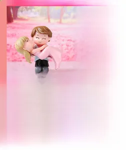 Handmade miniature cartoon couple figurine showing a romantic hug for DIY fairy gardens