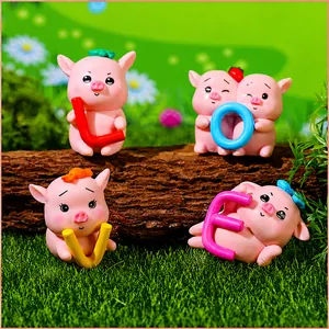 Detailed macro view of four cute resin piggy figurines holding colorful LOVE letters
