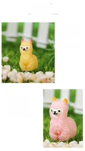 Detail view of miniature yellow and pink resin alpacas with textured fur for DIY gardening