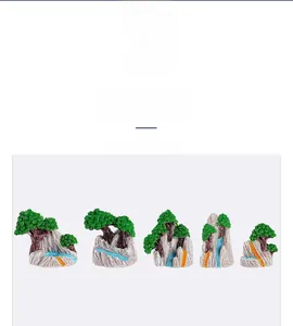 Close-up of a 5-piece miniature resin rockery and pine tree set for desk landscaping