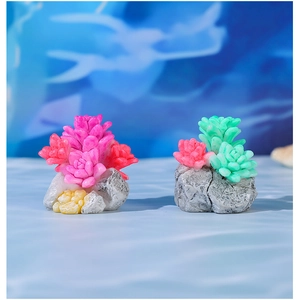 Detail view of miniature resin succulents on faux rock base for moss micro landscapes