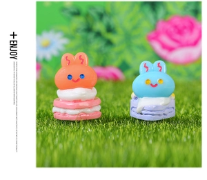 Macro view of cute rabbit resin figurines with macaron cream cake texture for DIY crafts