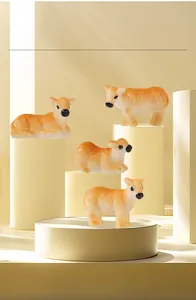 Detailed view of four miniature resin calf figurines in standing and lying poses