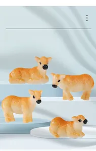 Detail view of four resin cow figurines in standing and lying poses for garden decor