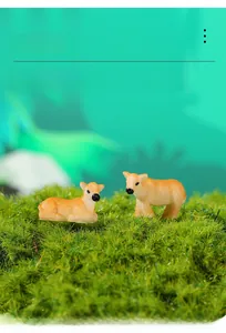 Close-up of miniature resin deer figurines with realistic fur textures on green moss bed
