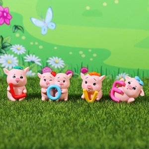 Cute pink pig resin figurines set holding colorful LOVE letters on green grass