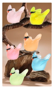Group of six colorful resin hummingbirds on wood and stones for micro landscape decor