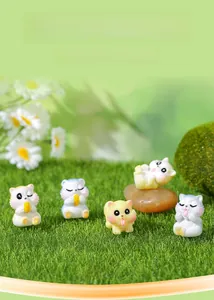 Macro shot of five cute resin squirrel figurines on moss for DIY miniature landscapes