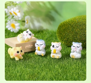 Close-up of five cute resin cat figurines in various playful poses for moss micro landscapes