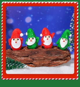 Miniature Christmas resin gnome figurines set on natural tree bark background
