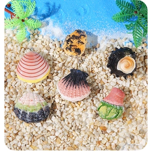Macro detail of six colorful resin sea shells on white sand for aquarium landscape decor