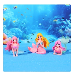 Detailed close-up of three creative mermaid figurines in a nautical moss micro landscape