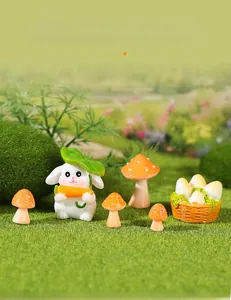 Miniature resin rabbit with orange mushrooms in a green fairy garden landscape