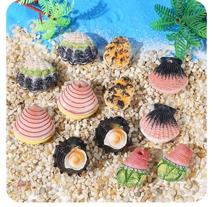 Resin colorful sea shells and conches on beach sand for DIY aquarium decor and jewelry