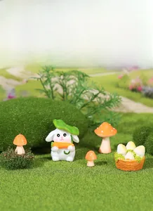Miniature resin rabbit with carrot and red mushrooms on mossy lawn for garden decor