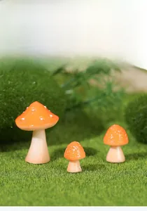 Detailed macro view of three miniature resin mushrooms for garden micro-landscape decor