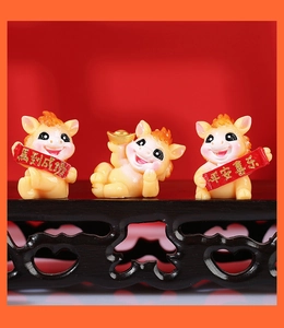 Detailed view of three festive yellow zodiac horse figurines on a wooden stand