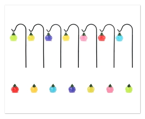 Close-up of colorful luminous pumpkin garden stakes in seven vibrant resin finishes