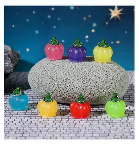 Close-up of colorful resin flower charms on stone with a starry night background scene