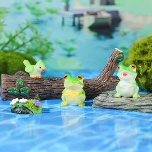 Miniature resin figurines set with green frogs and a small bird for garden decor