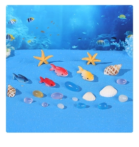 Close-up of resin starfish and seashells on blue sand for aquarium micro-landscaping