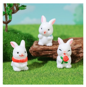 Detailed trio of miniature resin bunnies in a forest landscape micro-landscape setup