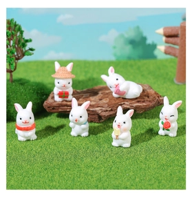 Detailed set of five miniature resin bunnies in garden scenery with hats and gifts