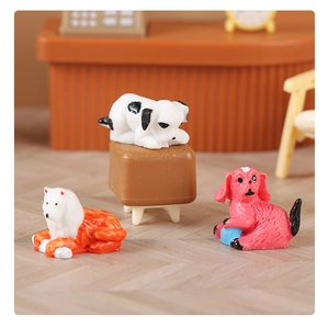 Miniature resin puppy figurines set on tiny desk for dollhouse and landscape decor