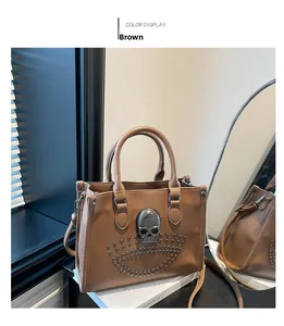 Detailed close-up of brown PU leather bag with silver rhinestone skull and metal rivets
