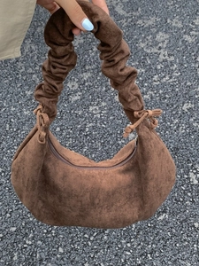 Brown suede crescent bag with pleated handle and drawstring detail for women