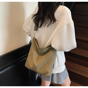 Detail of the large canvas bucket bag with a stylish patterned wide shoulder strap