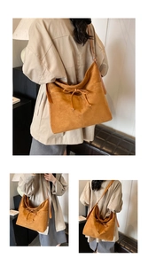 Macro shot of retro caramel tote bag showing exquisite suede texture and white contrast stitching